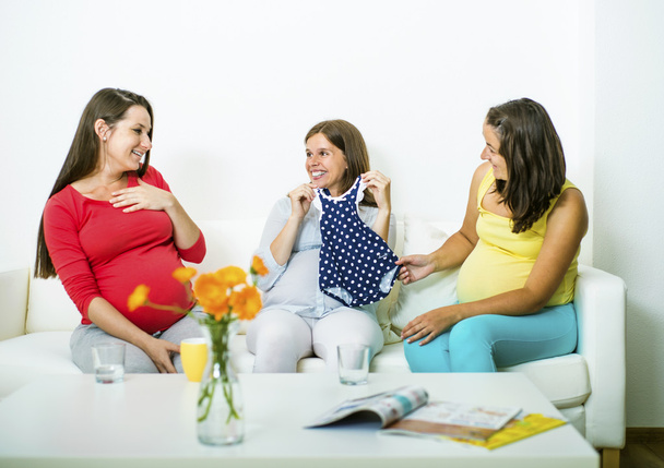 Pregnant women looking at baby shower gifts - Фото, изображение