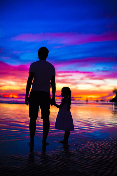 Father and daughter silhouettes in sunset at the beach on Boracay - Photo, Image