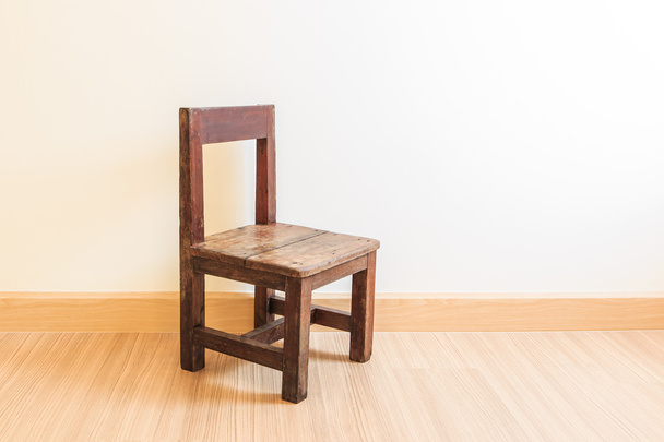 Old wooden chair on laminate flooring - Φωτογραφία, εικόνα