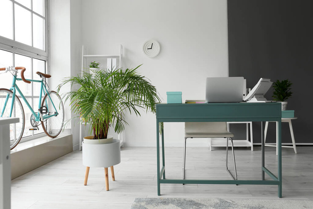 Workplace with modern laptop and landline phone in stylish office interior - Photo, Image