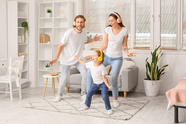 Happy young family listening to music at home - Foto, imagen