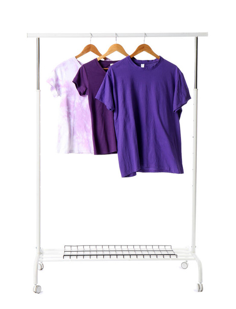 Regal mit T-Shirts auf weißem Hintergrund - Foto, Bild