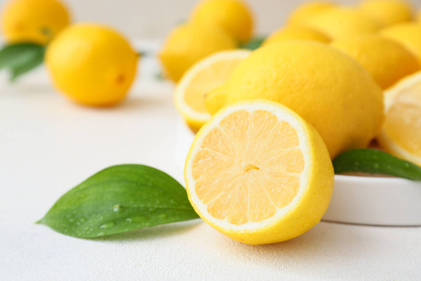 Many fresh lemons on light table, closeup - Φωτογραφία, εικόνα