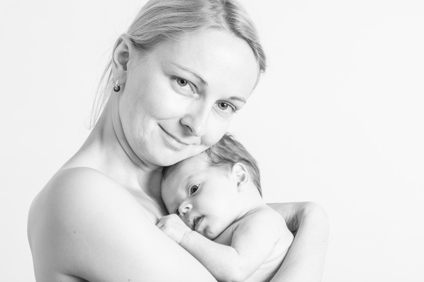 Baby girl in a mother's arms - Foto, imagen
