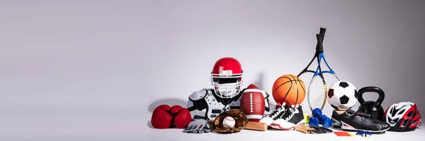 Variety Of Sport Balls And Equipment In Front Of Gray Surface - Valokuva, kuva