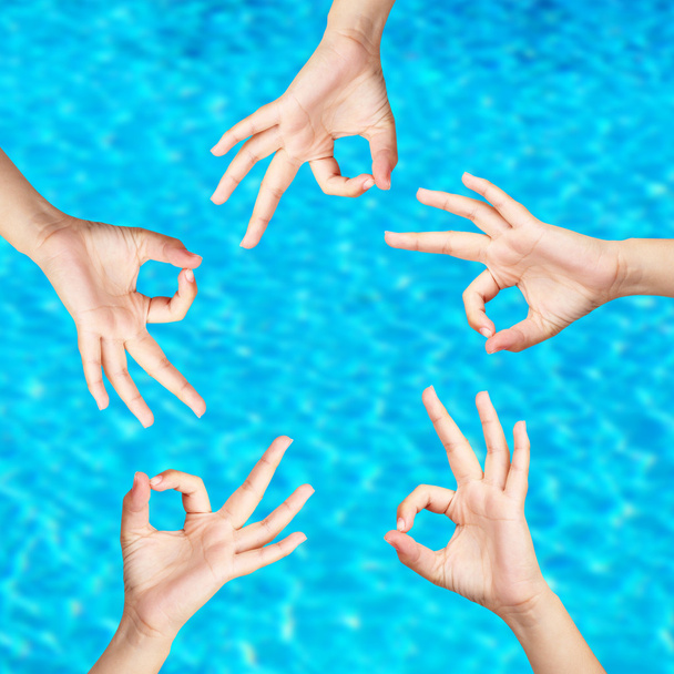 People's hands on water background - 写真・画像