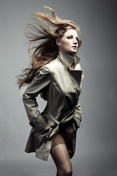 Fashion portrait of young beautiful woman in the raincoat - Foto, Imagem