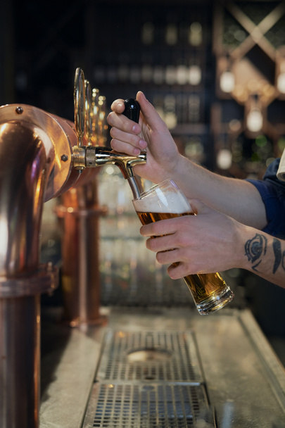 Primer plano del camarero que sirve cerveza en el bar - Foto, Imagen