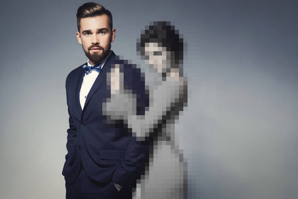 Online dating concept. Find your love in internet. Handsome man wearing suit in embrace with unrecognizable woman. - Фото, зображення