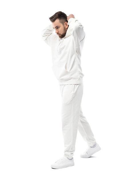 Handsome man wearing blank white hoodie and pants isolated on white background - Valokuva, kuva