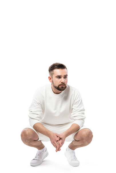 Handsome man wearing white sweatshirt and shorts isolated on white background - Foto, imagen