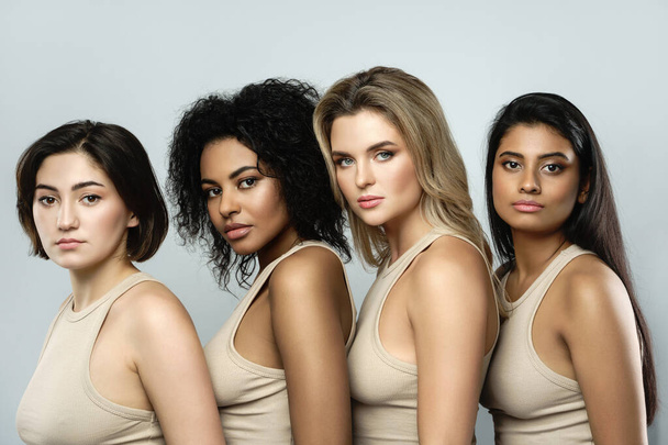 Multi-ethnic beauty and friendship. Group of beautiful different ethnicity women on gray background. - Fotoğraf, Görsel
