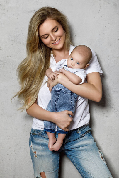 Portrait of beautiful young mother with her cute baby boy  - Valokuva, kuva
