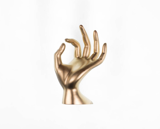painted golden hands isolated on gold background - Fotó, kép