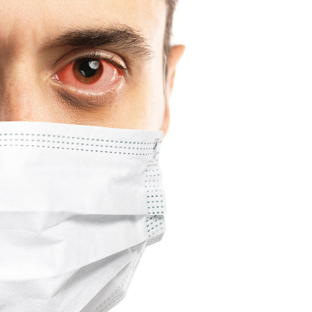 Caucasian man with virus symptoms wearing prevention mask on white background - Foto, Imagem
