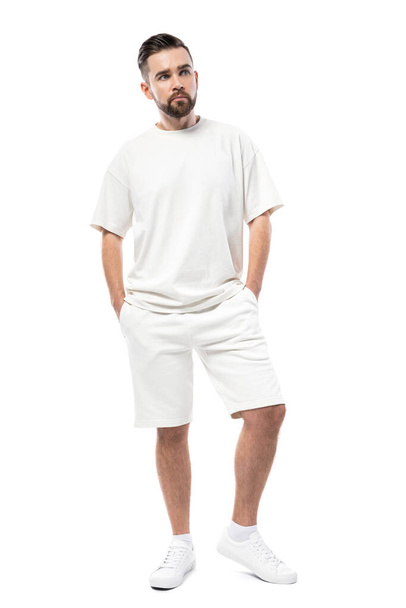 Handsome man wearing blank white t-shirt and shorts isolated on white background - Foto, Imagen