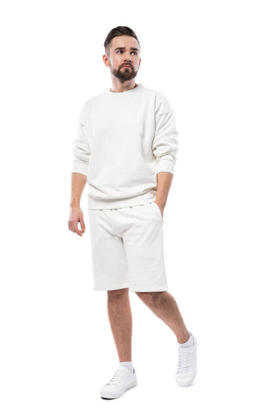 Handsome man wearing blank white sweatshirt and shorts isolated on white background - Foto, Imagen