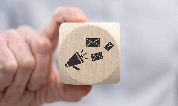 Hand holding a wooden cube with symbol of newsletter concept - Фото, изображение