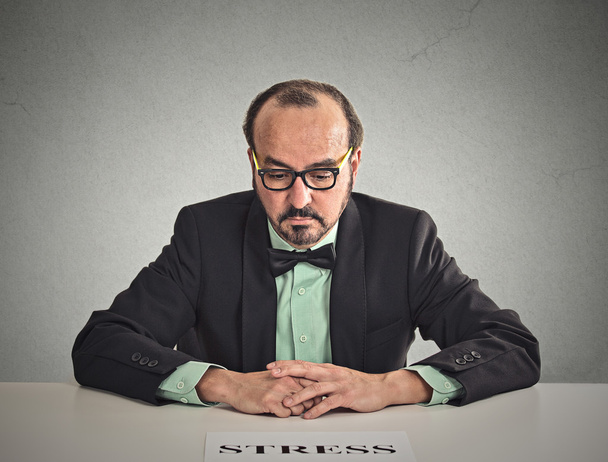 Sad stressed man sitting at office desk - Fotografie, Obrázek