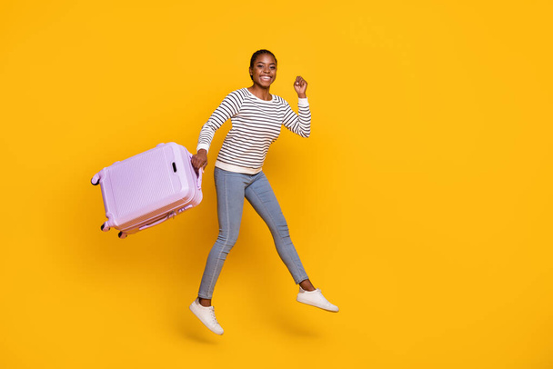 Full size photo of young girl jump journey weekend abroad fly low-cost isolated over yellow color background - Fotoğraf, Görsel