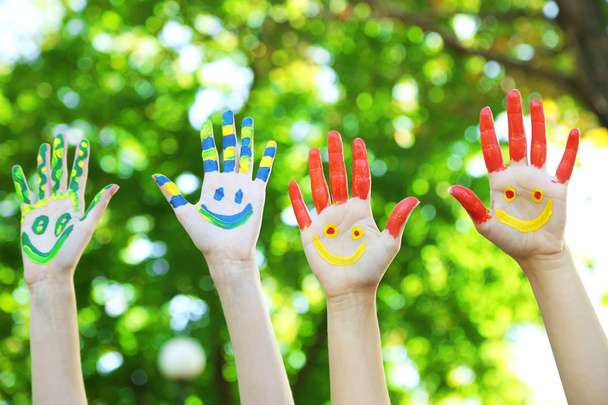 Smiling colorful hands on natural background - Fotografie, Obrázek