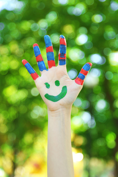 Smiling colorful hand on natural background - Fotó, kép