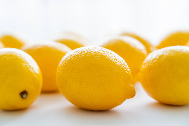 Close up view of fresh lemons with light on white background  - Foto, immagini