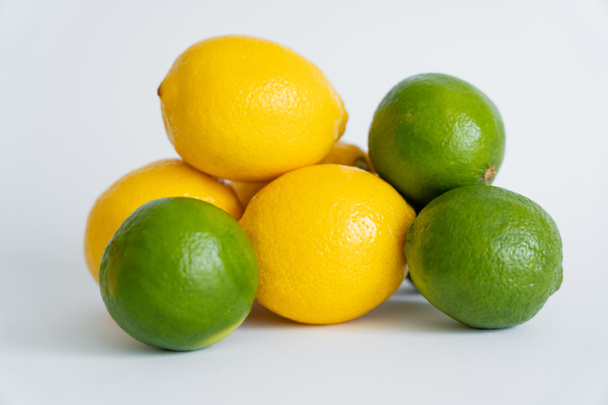 Fresh limes and limes on white surface  - Fotó, kép