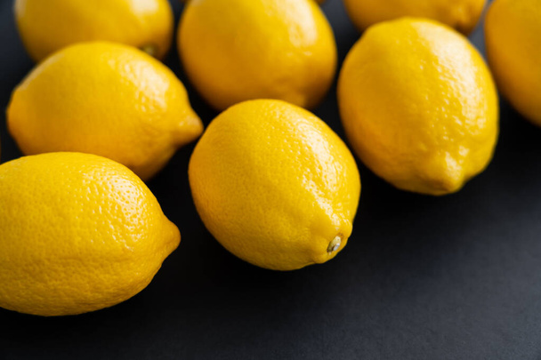 Close up view of fresh lemons on black background  - Фото, изображение