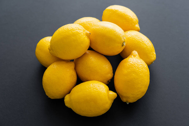 Top view of fresh and juicy lemons on black background  - Photo, image