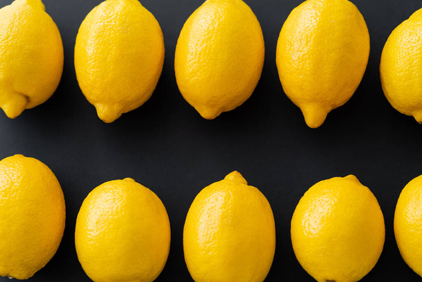 Flat lay with organic lemons on black background  - Zdjęcie, obraz