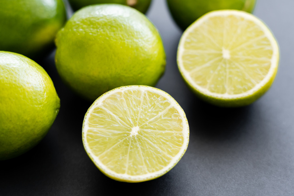 Close up view of fresh half of lime on black background  - 写真・画像