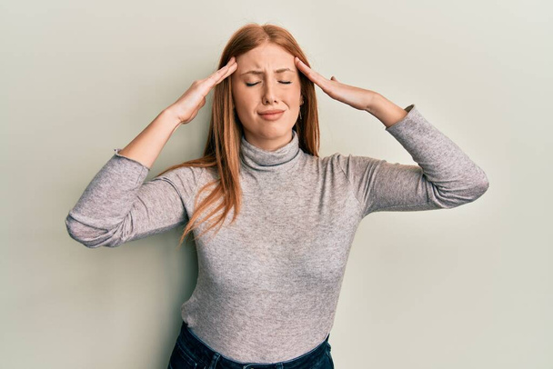 Young irish woman wearing casual clothes with hand on head, headache because stress. suffering migraine.  - Fotoğraf, Görsel