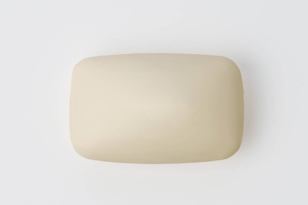 A bar of soap on a light background. Detergent for hygienic cosmetics or household chemicals. - 写真・画像