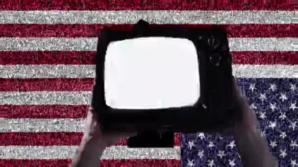 Hands holding Retro TV with Clenched Fist on Screen over a Retro TV Wall with USA Flag. Black Lives anyag koncepció.  - Felvétel, videó