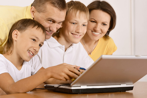 Happy family with laptop - 写真・画像