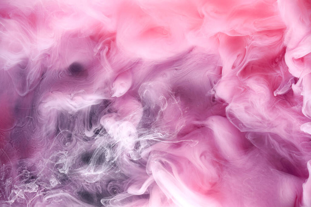 Pink gray smoke on black ink background, colorful fog, abstract swirling touch ocean sea, acrylic paint pigment underwater - Photo, image