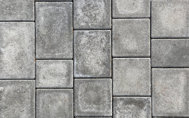 Груба текстурована поверхня великих сірих тротуарних плит, крупним планом. Візерунок тротуарної плитки, вид зверху
 - Фото, зображення