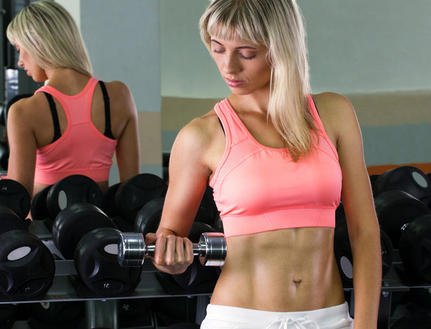young woman with dumbbells - Foto, imagen