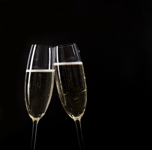 Champagne pouring in two glasses from a bottle  - Fotoğraf, Görsel