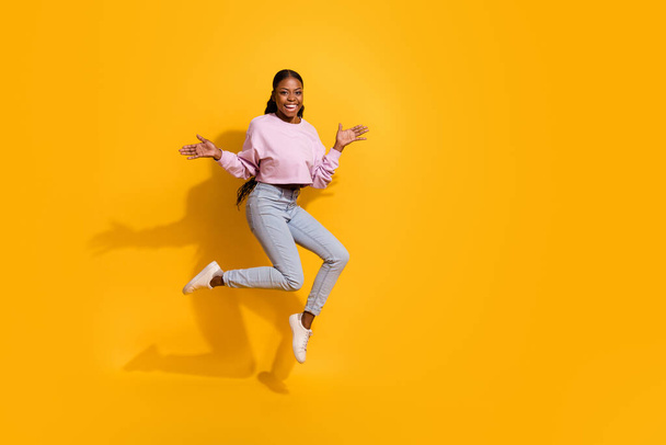 Full length photo of overjoyed cheerful girl raise arms palms isolated on yellow color background - Fotografie, Obrázek