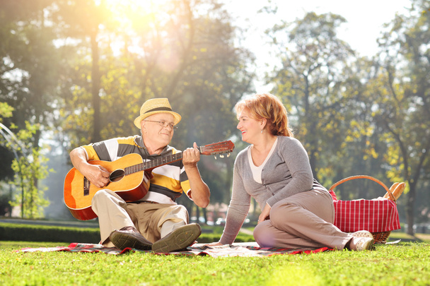 Senior playing guitar for his wife - Photo, Image