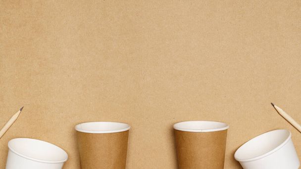 Eco friendly concept, Consist of paper cup and pencil with cotton buds on wooden background. - Photo, Image