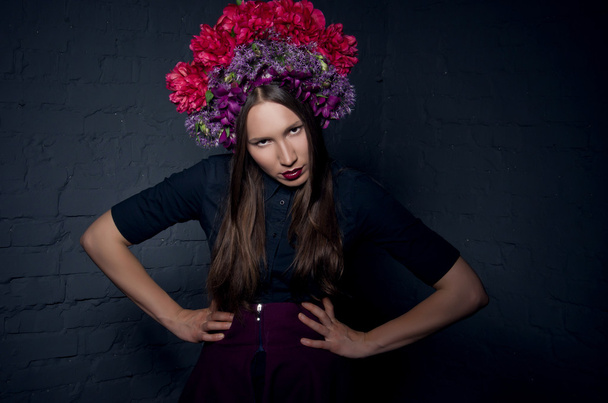 Beautiful femme fatale in a headdress from fresh colorful flower - Valokuva, kuva