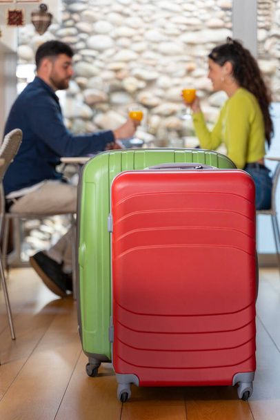 Luggage of young tourist couple in love having breakfast in a hotel - Photo, Image