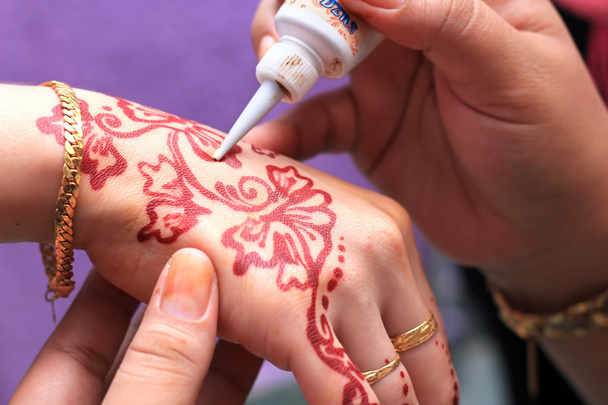 Hand being decorated with henna tattoo - Fotó, kép