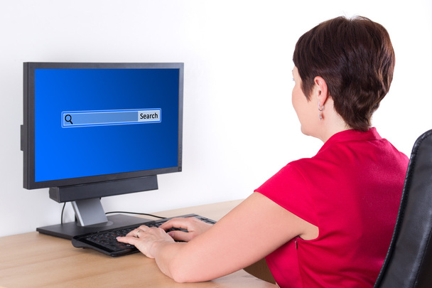 Business woman searching something in internet using pc - Photo, Image