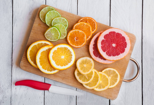 slices of fresh citrus fruits, food background - Foto, Imagem