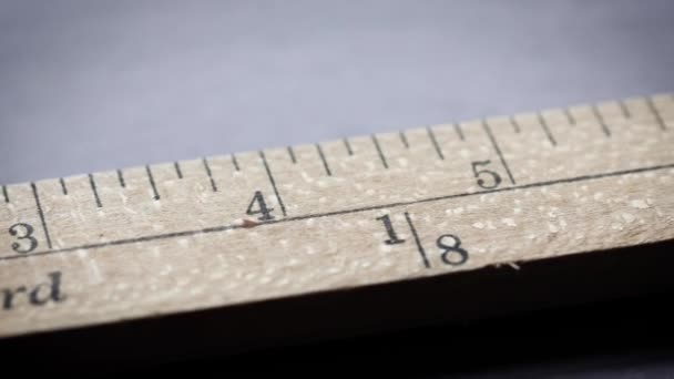 An yardstick with scales in yards and inches sliding in front of the camera - Footage, Video