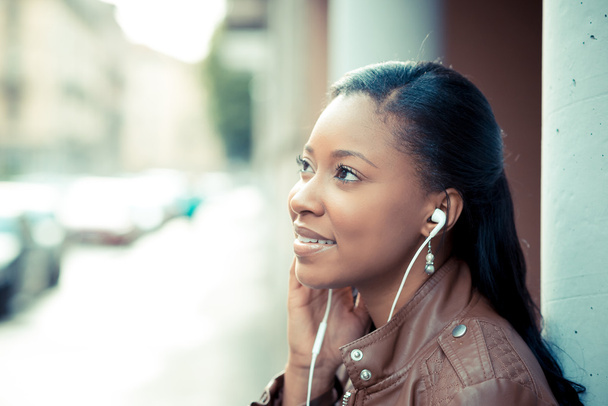 beautiful african young woman listening music earphones - Foto, Imagen